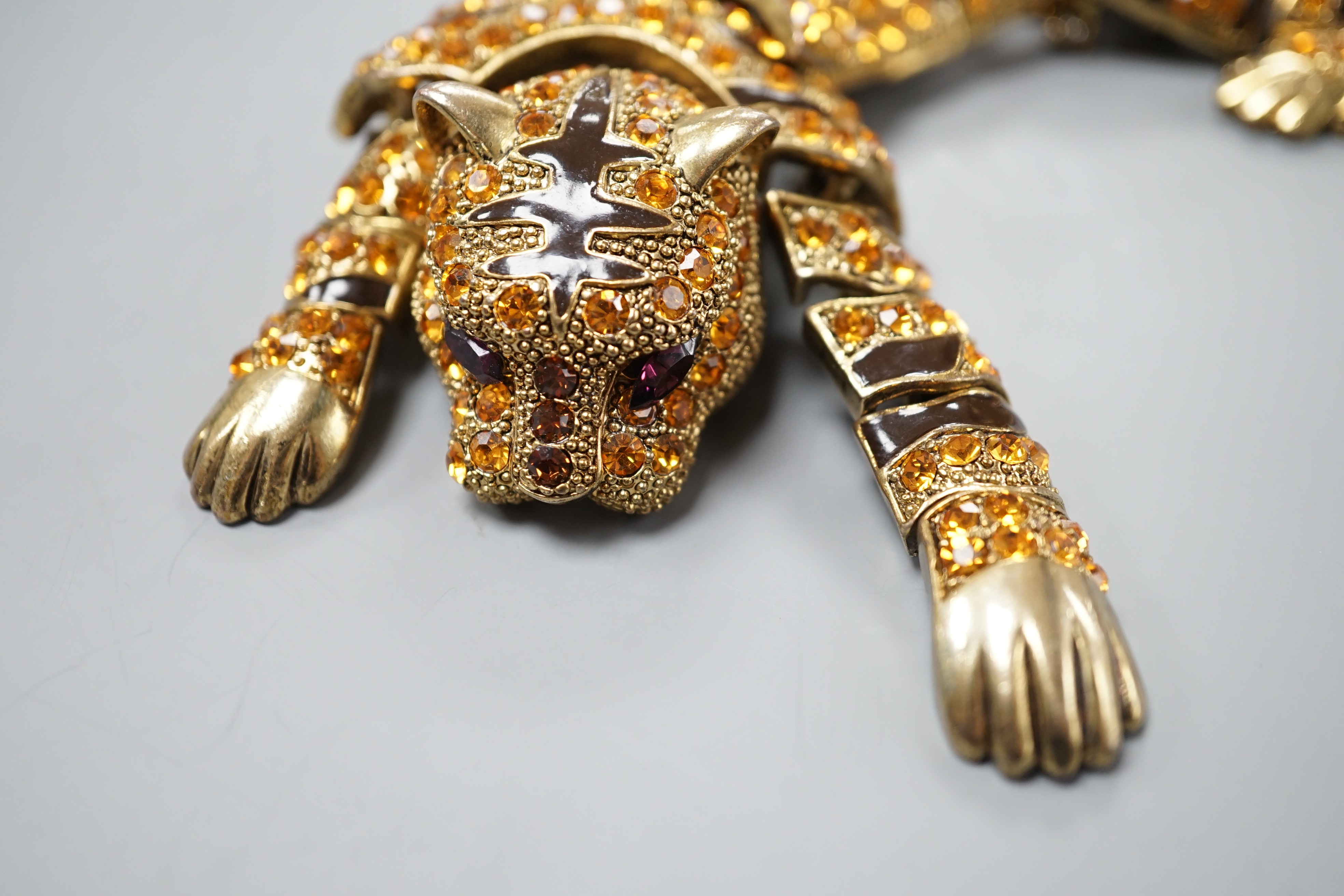 A costume gilt metal and paste set tiger shoulder? ornament, 24.5cm.